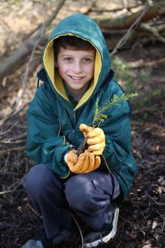 A student shows the type of indigenous plants that are being planted.